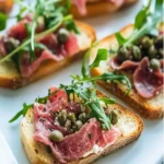 Savory Beef Carpaccio Crostini with Garlic Aioli Delight First Image First Image
